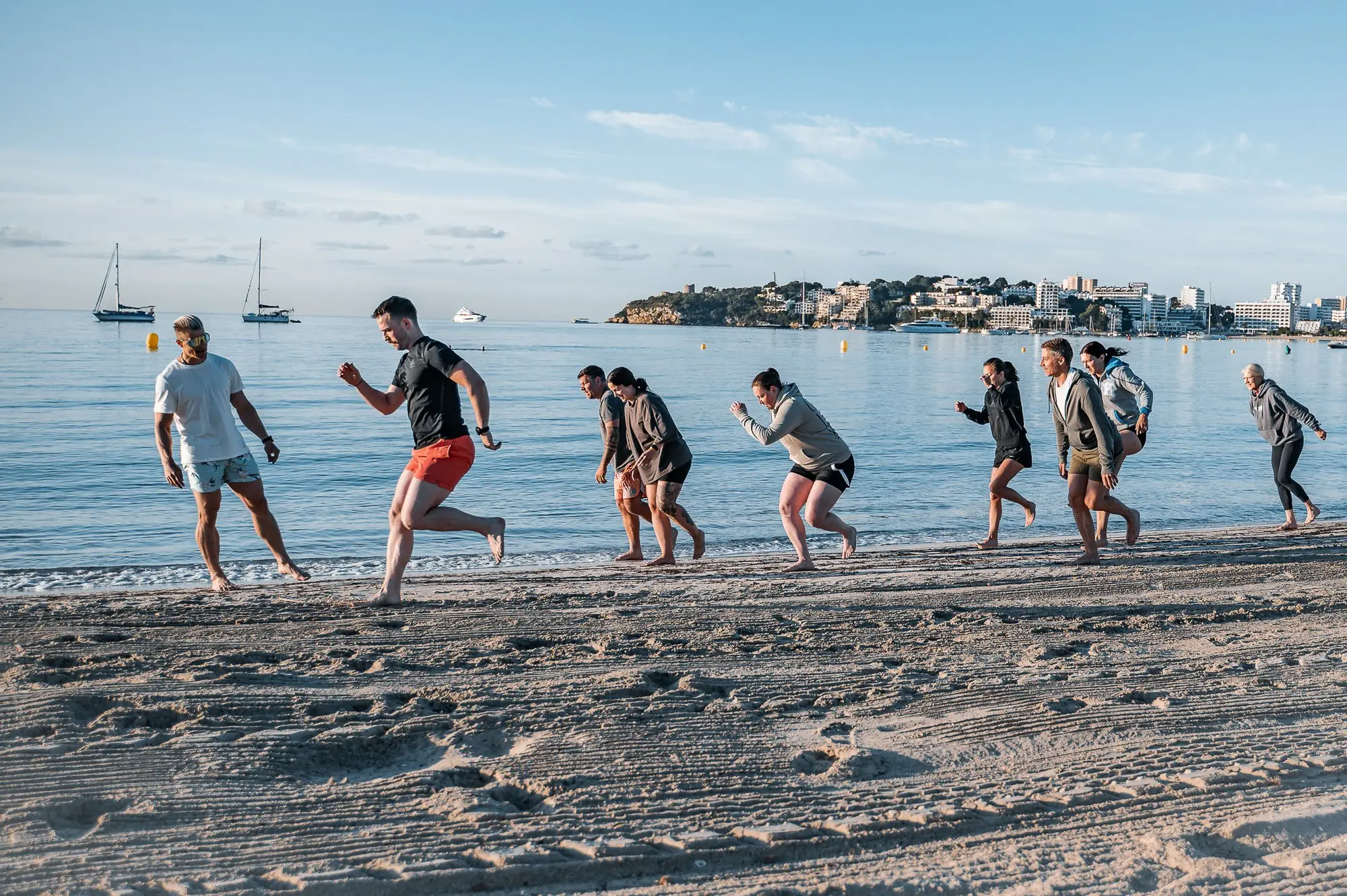 Camp participants running on the beach