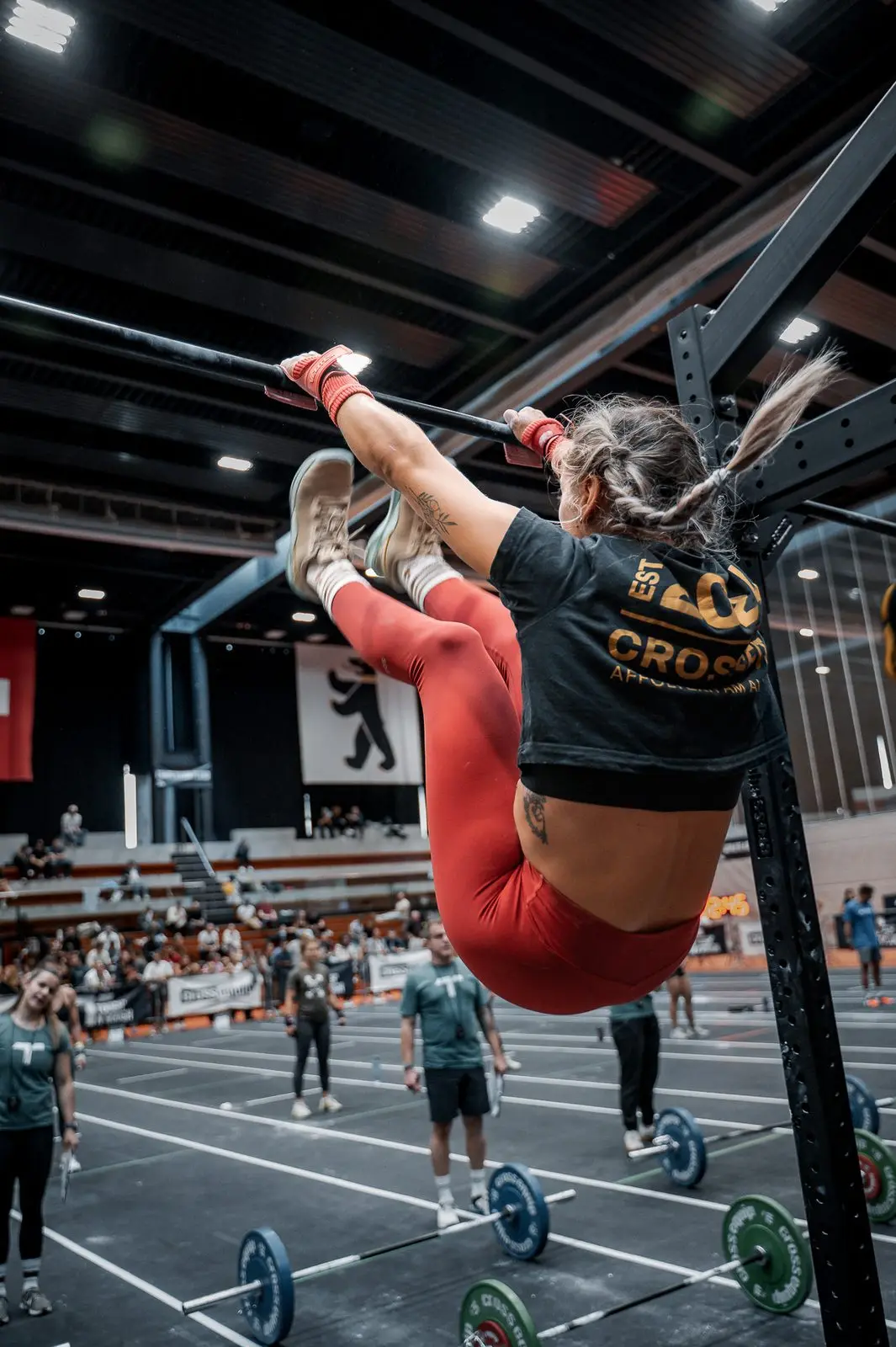 Athlete on a gymnastics bar during a functional fitness competition